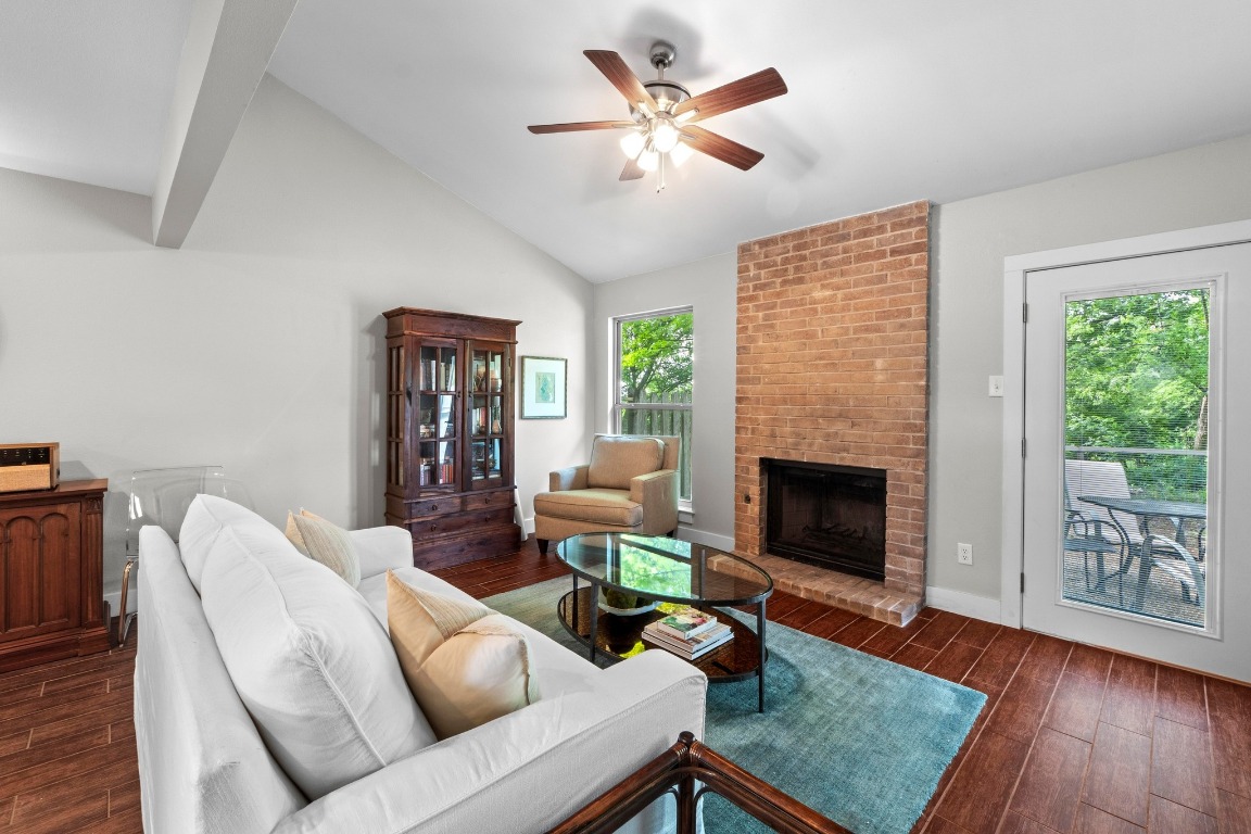 a living room with furniture a table and a fireplace