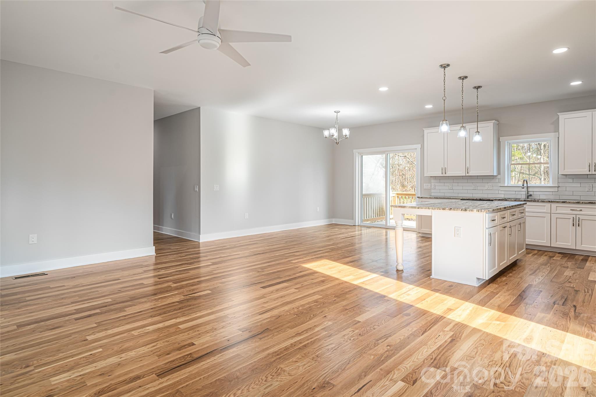 93 Locust Grove Road Weaverville, NC 28787 - Photo 13 of 26 a large kitchen with granite countertop a large counter top a sink and cabinets