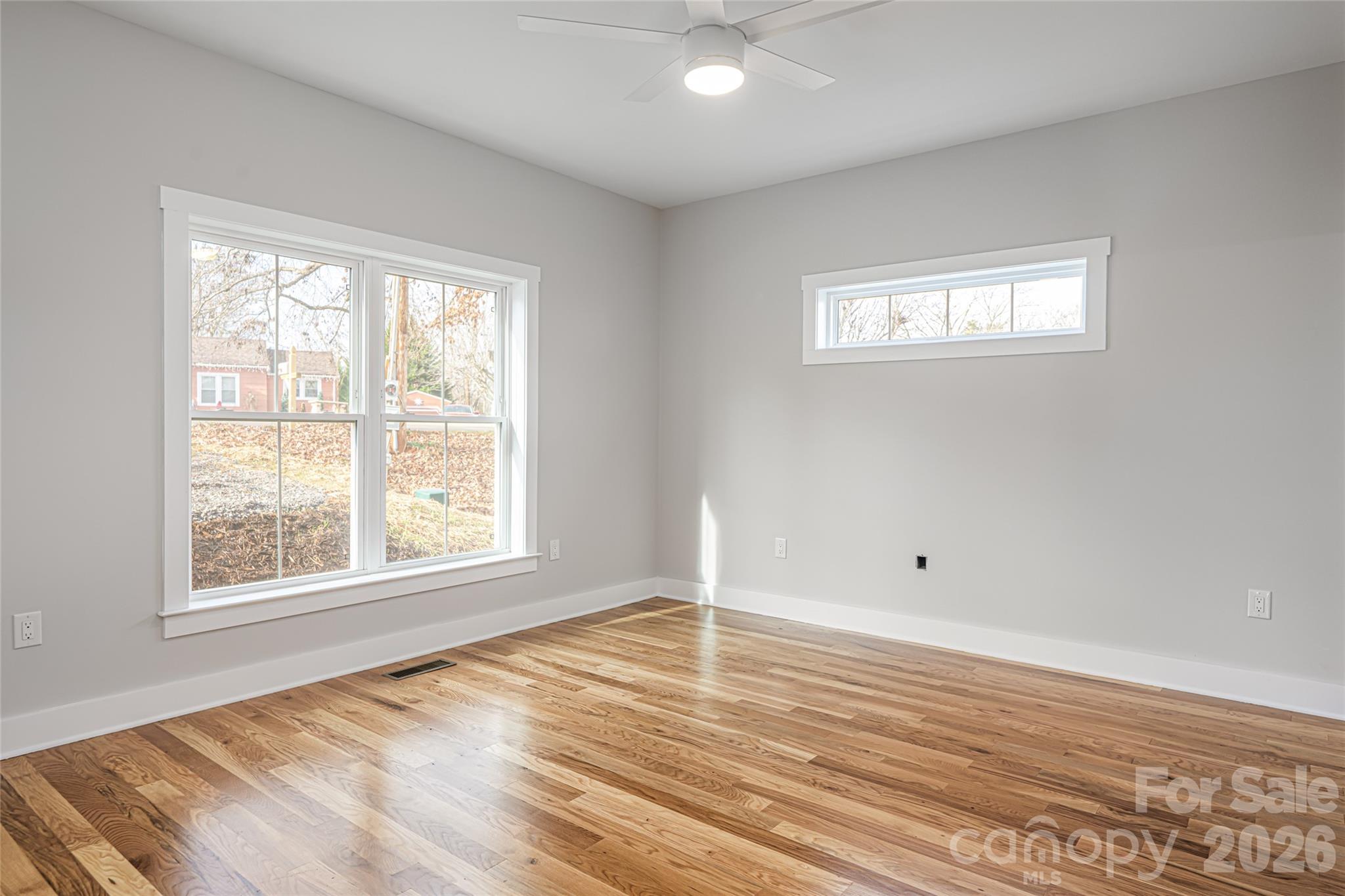 93 Locust Grove Road Weaverville, NC 28787 - Photo 14 of 26 an empty room with wooden floor and windows