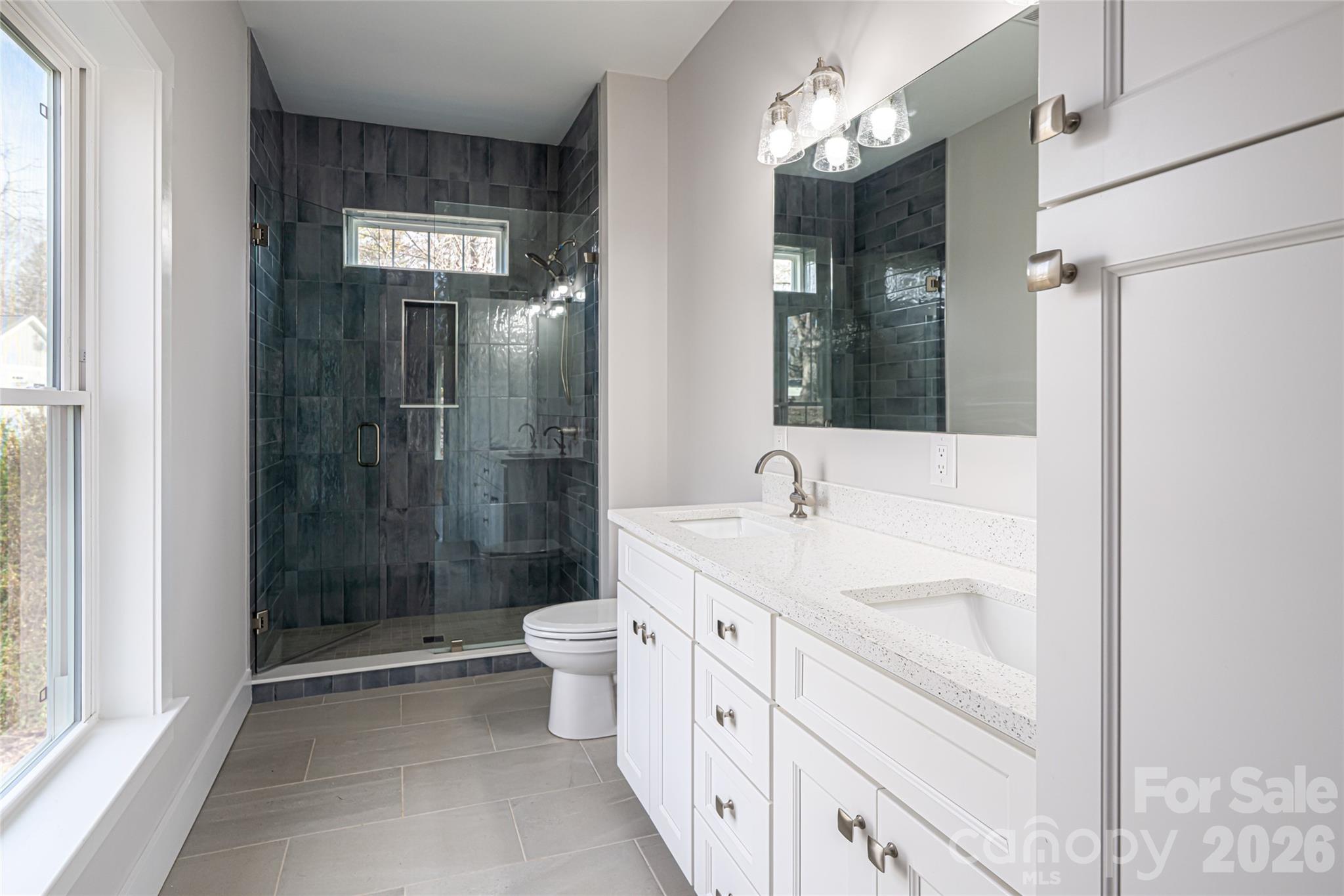 93 Locust Grove Road Weaverville, NC 28787 - Photo 17 of 26 a bathroom with a double vanity sink toilet and shower