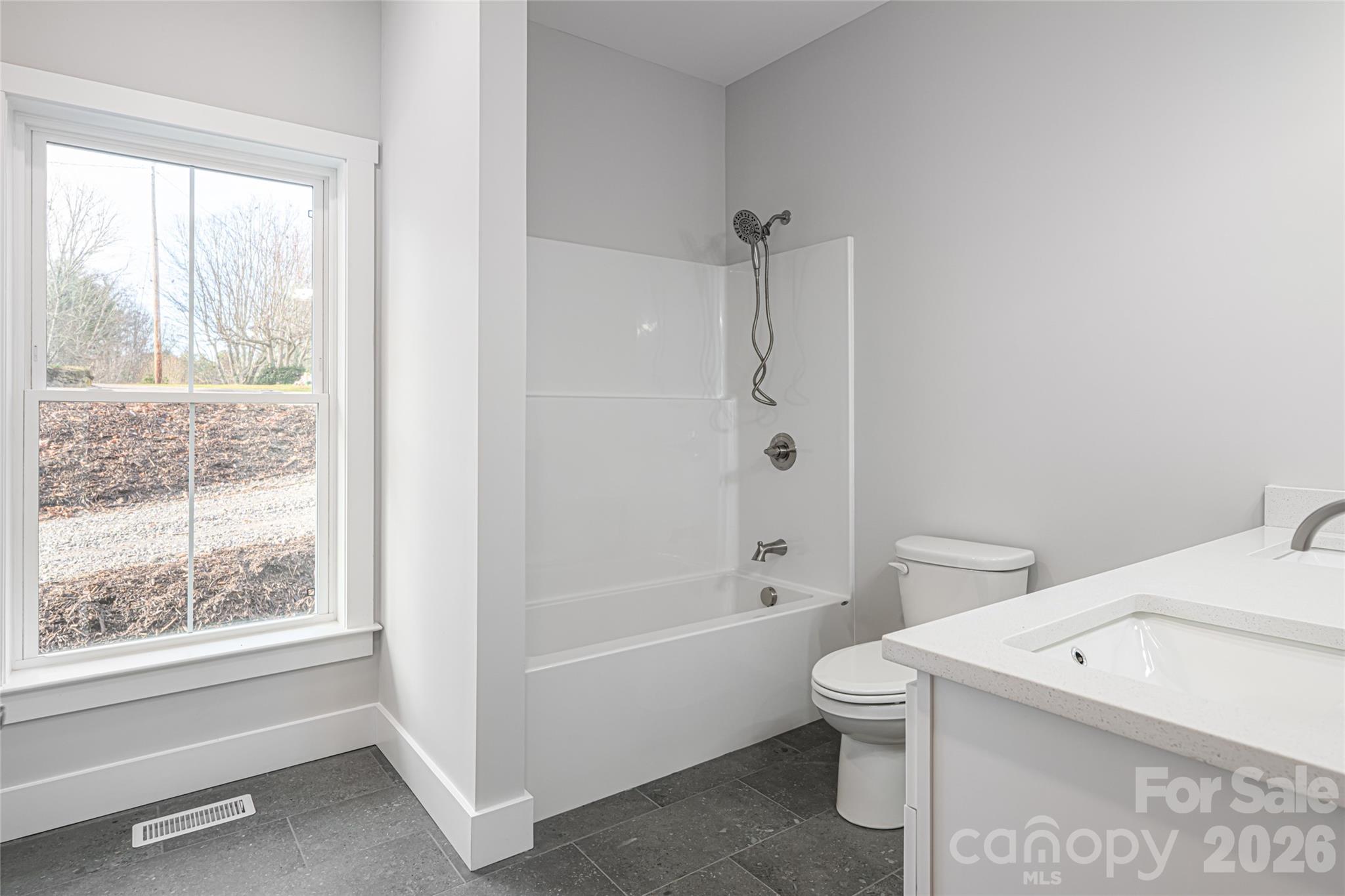 93 Locust Grove Road Weaverville, NC 28787 - Photo 21 of 26 a bathroom with a toilet a sink and a bathtub