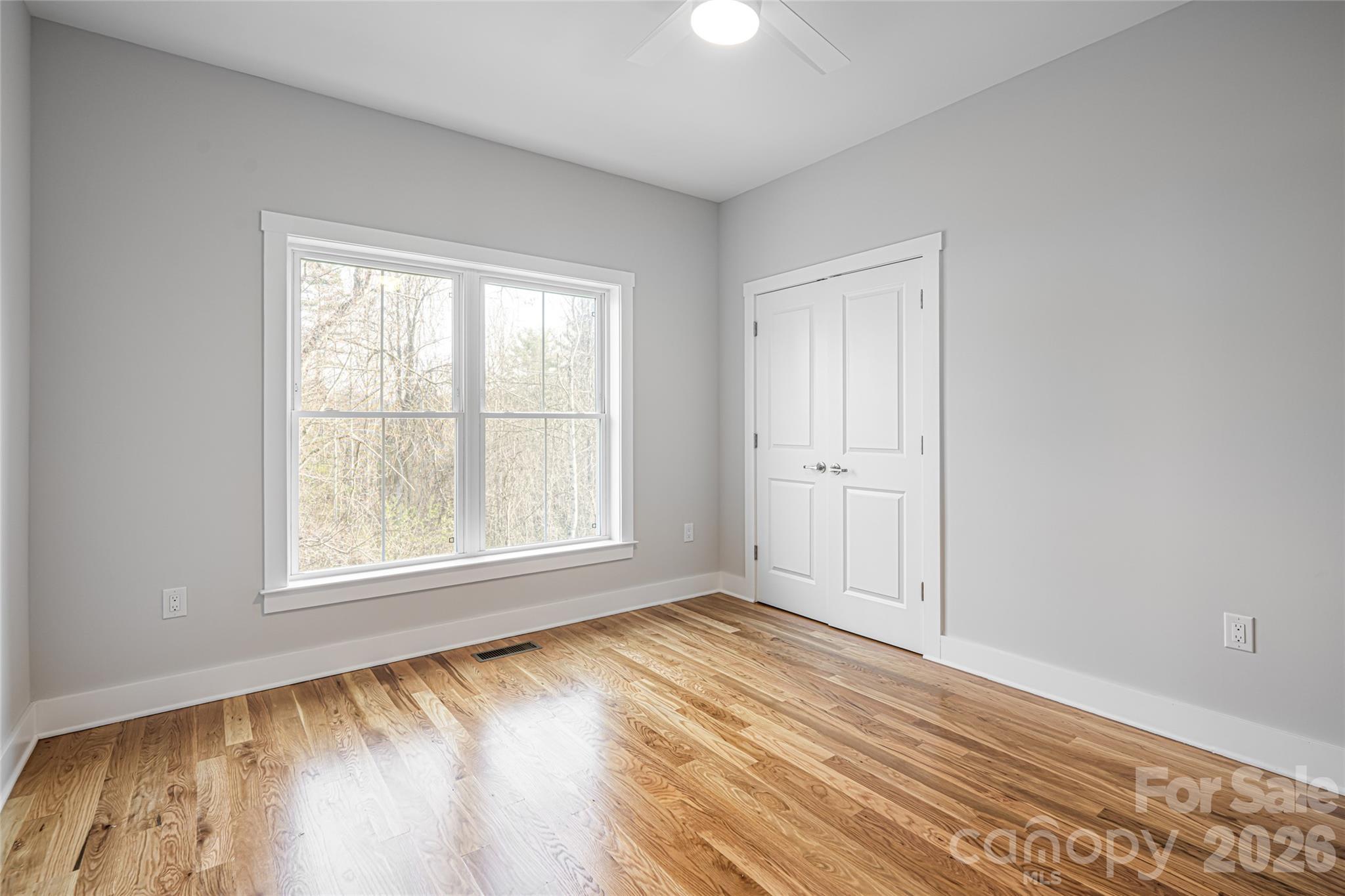93 Locust Grove Road Weaverville, NC 28787 - Photo 23 of 26 an empty room with wooden floor and windows