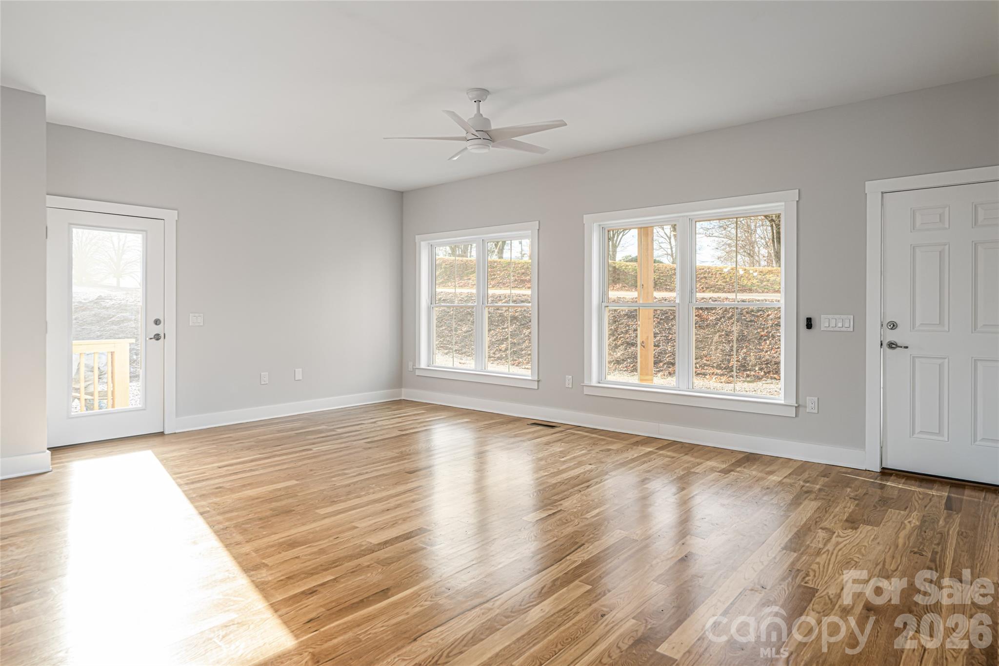 93 Locust Grove Road Weaverville, NC 28787 - Photo 4 of 26 a view of an empty room with wooden floor and a window