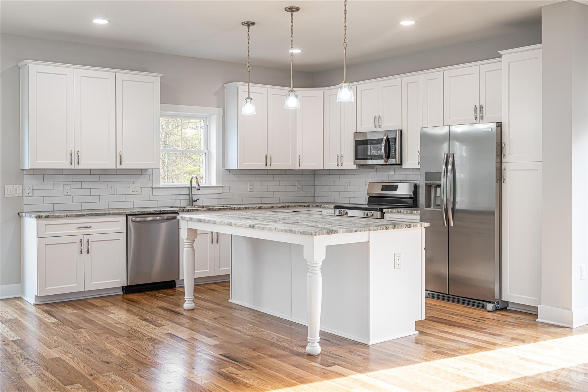 93 Locust Grove Road Weaverville, NC 28787 - Photo 5 of 26 a kitchen with stainless steel appliances granite countertop a stove a refrigerator and a sink