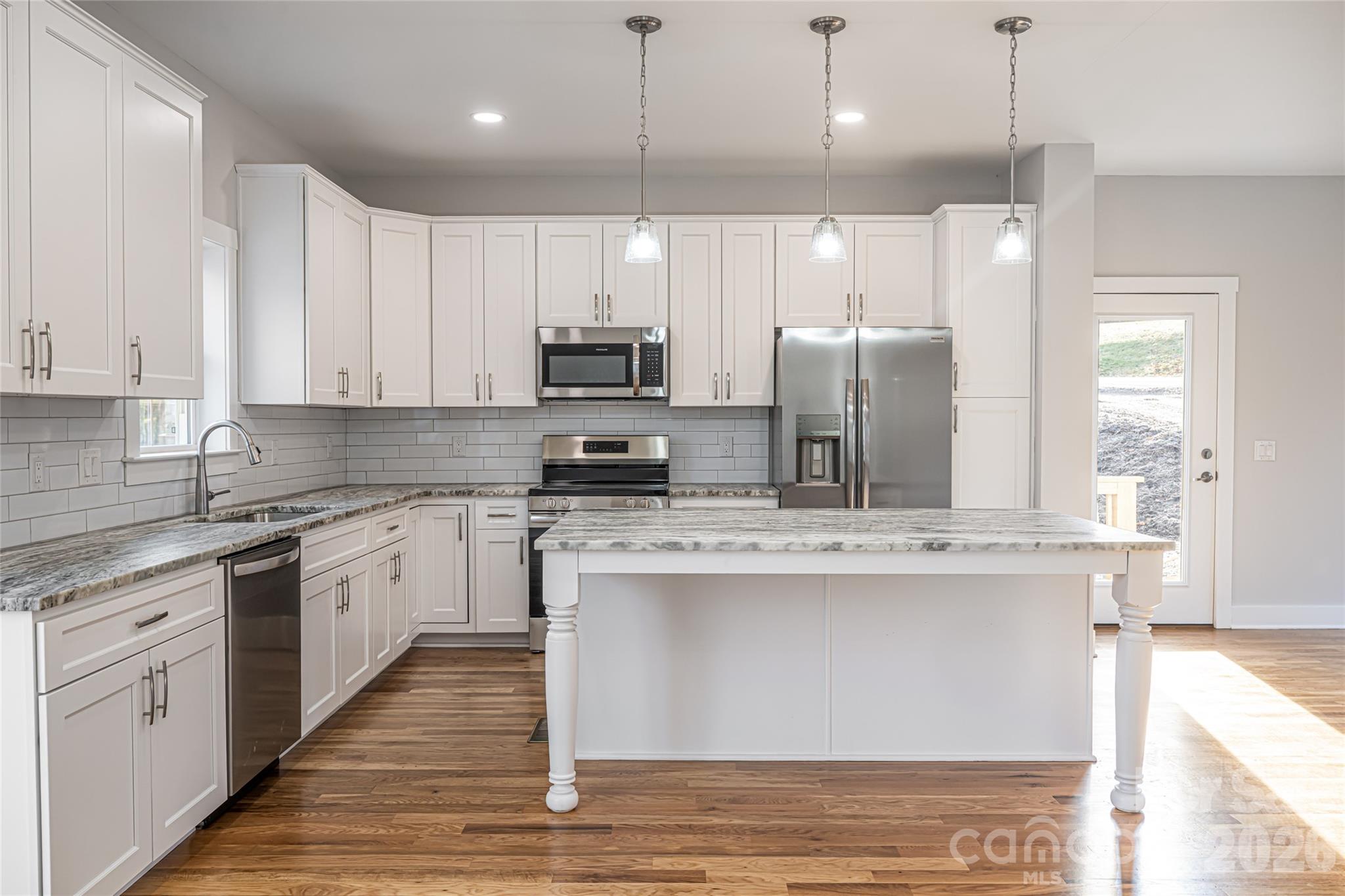 93 Locust Grove Road Weaverville, NC 28787 - Photo 6 of 26 a kitchen with stainless steel appliances granite countertop a sink a stove and cabinets