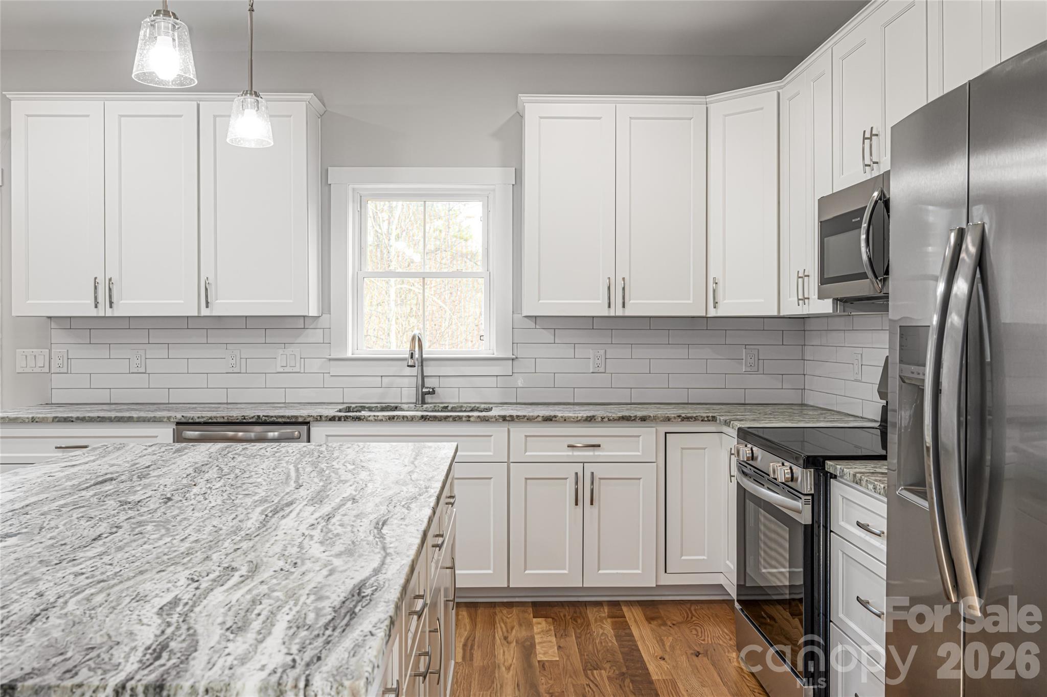 93 Locust Grove Road Weaverville, NC 28787 - Photo 8 of 26 a kitchen with stainless steel appliances granite countertop a sink a stove a refrigerator and island