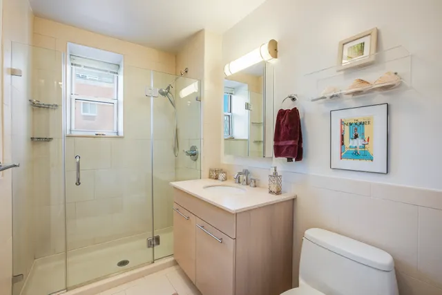 a bedroom with bed and a painting on the wall