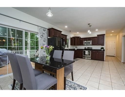34 Tannery Road Sturbridge, MA 01518 - Photo 7 of 33 a living room with furniture and a dining table with kitchen view