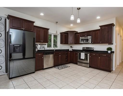 34 Tannery Road Sturbridge, MA 01518 - Photo 8 of 33 a kitchen with stainless steel appliances kitchen island granite countertop a refrigerator a sink a stove a microwave and island