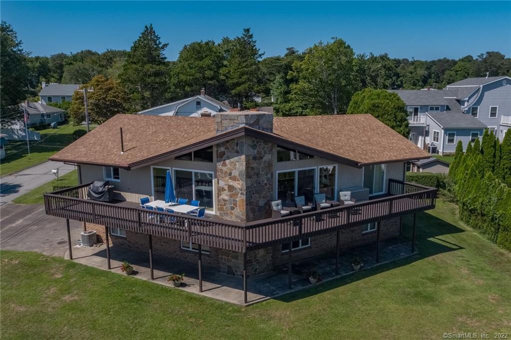 a aerial view of a house with swimming pool and sitting area