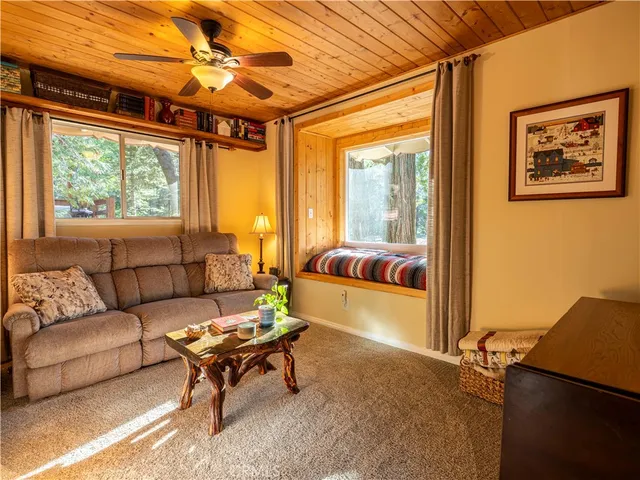a sitting area with wooden deck and outdoor space