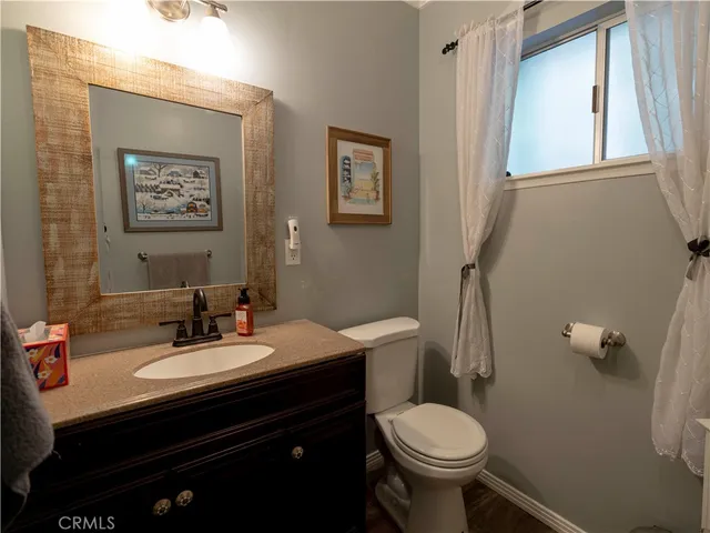 a view of a balcony with wooden floor and fence