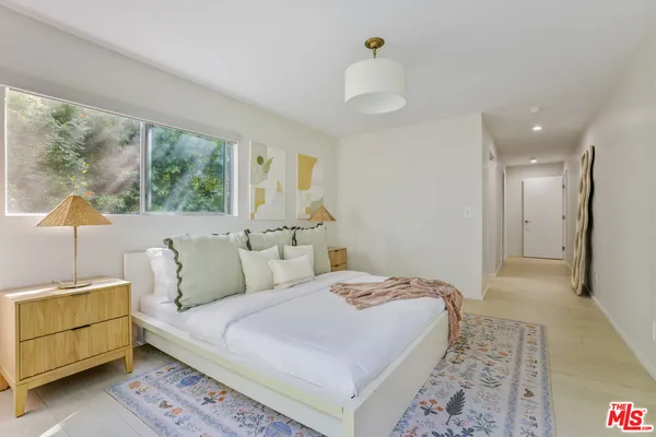 a bedroom with a bed and a window