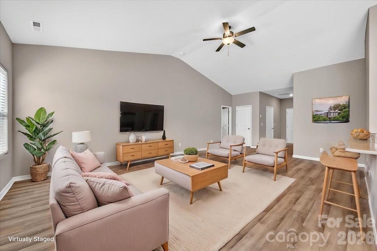 4322 One Mile Way Charlotte, NC 28215 - Photo 12 of 48 a living room with furniture a rug and a flat screen tv