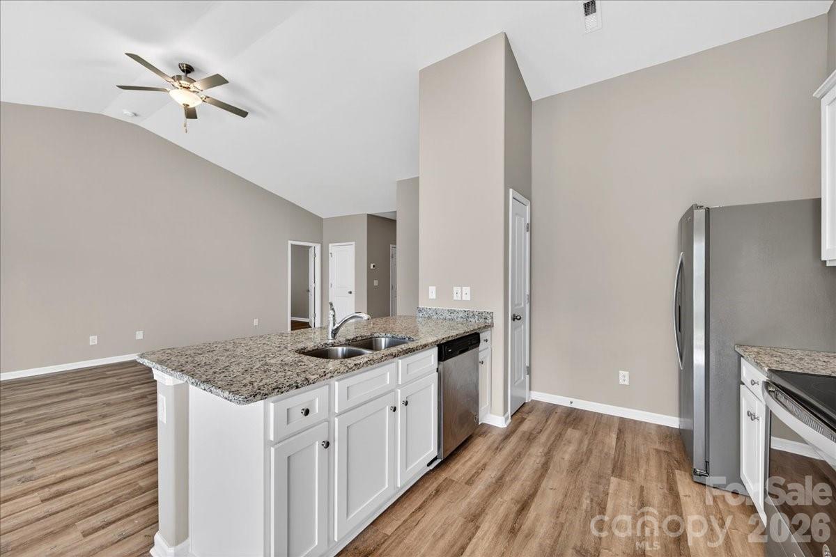 4322 One Mile Way Charlotte, NC 28215 - Photo 15 of 48 a kitchen with a sink stove and refrigerator