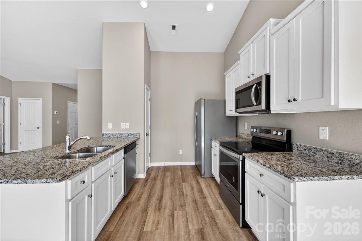 4322 One Mile Way Charlotte, NC 28215 - Photo 16 of 48 a kitchen with stainless steel appliances granite countertop a stove a sink and a refrigerator