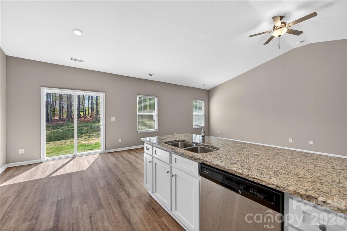 4322 One Mile Way Charlotte, NC 28215 - Photo 19 of 48 a kitchen that has a sink a stove and cabinets
