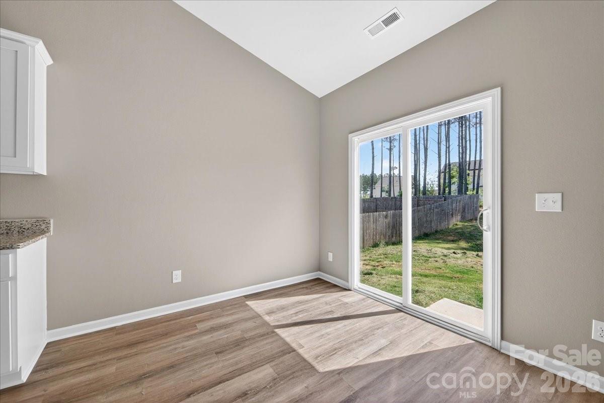 4322 One Mile Way Charlotte, NC 28215 - Photo 22 of 48 a view of an empty room with wooden floor and windows