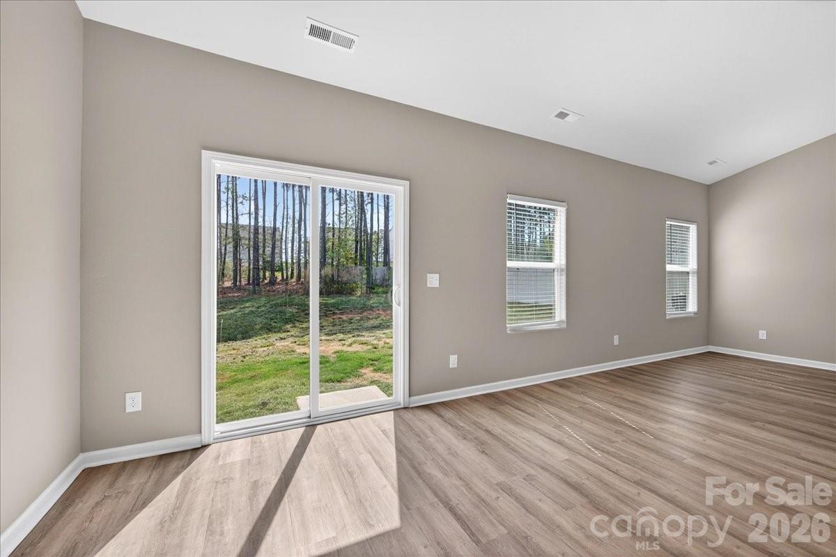 4322 One Mile Way Charlotte, NC 28215 - Photo 23 of 48 a view of an empty room with wooden floor and windows