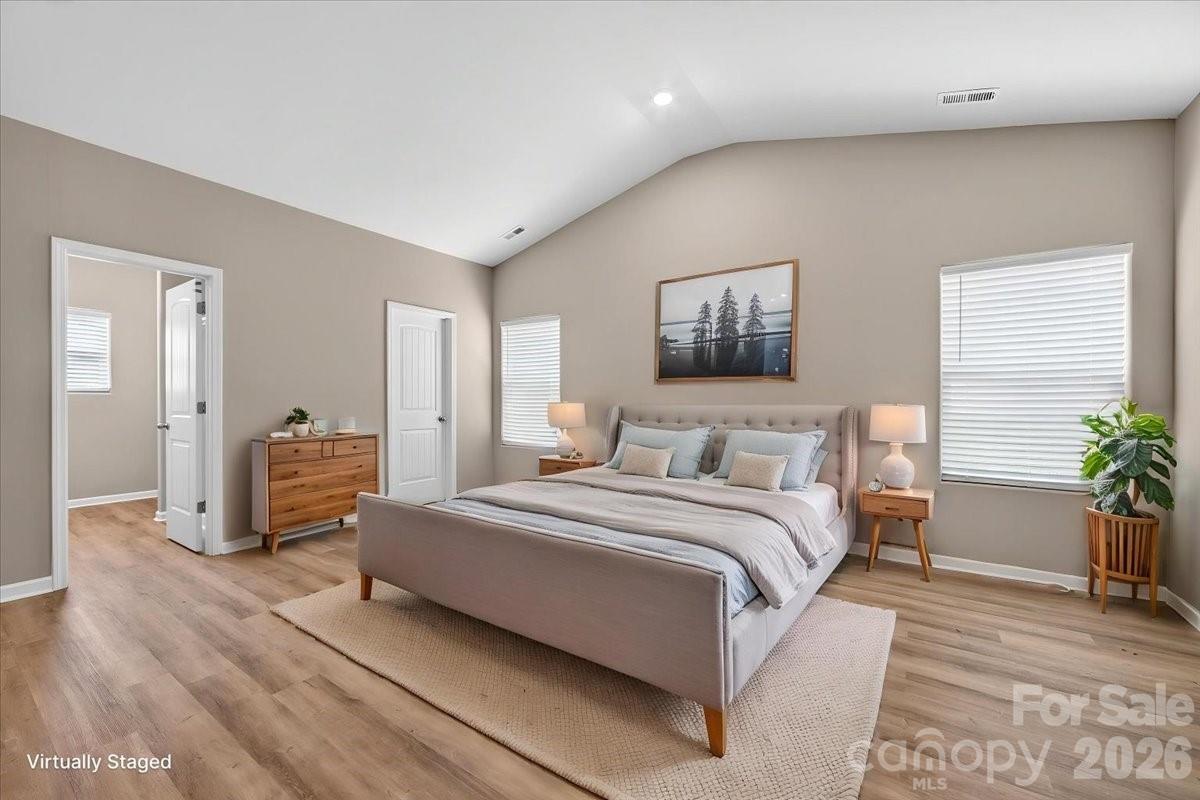 4322 One Mile Way Charlotte, NC 28215 - Photo 25 of 48 a spacious bedroom with a bed and a couch