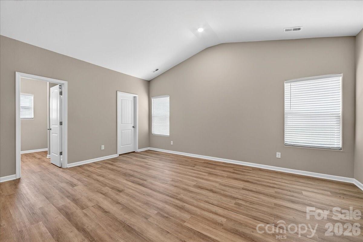 4322 One Mile Way Charlotte, NC 28215 - Photo 26 of 48 a view of an empty room with wooden floor and a window