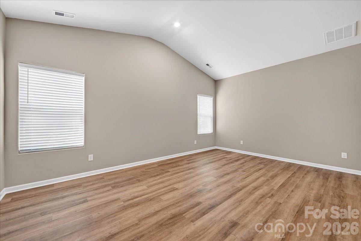 4322 One Mile Way Charlotte, NC 28215 - Photo 27 of 48 a view of an empty room with wooden floor and a window