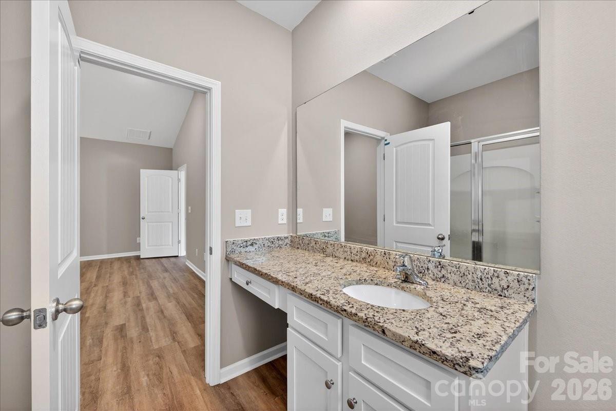 4322 One Mile Way Charlotte, NC 28215 - Photo 30 of 48 a bathroom with a granite countertop sink and a mirror