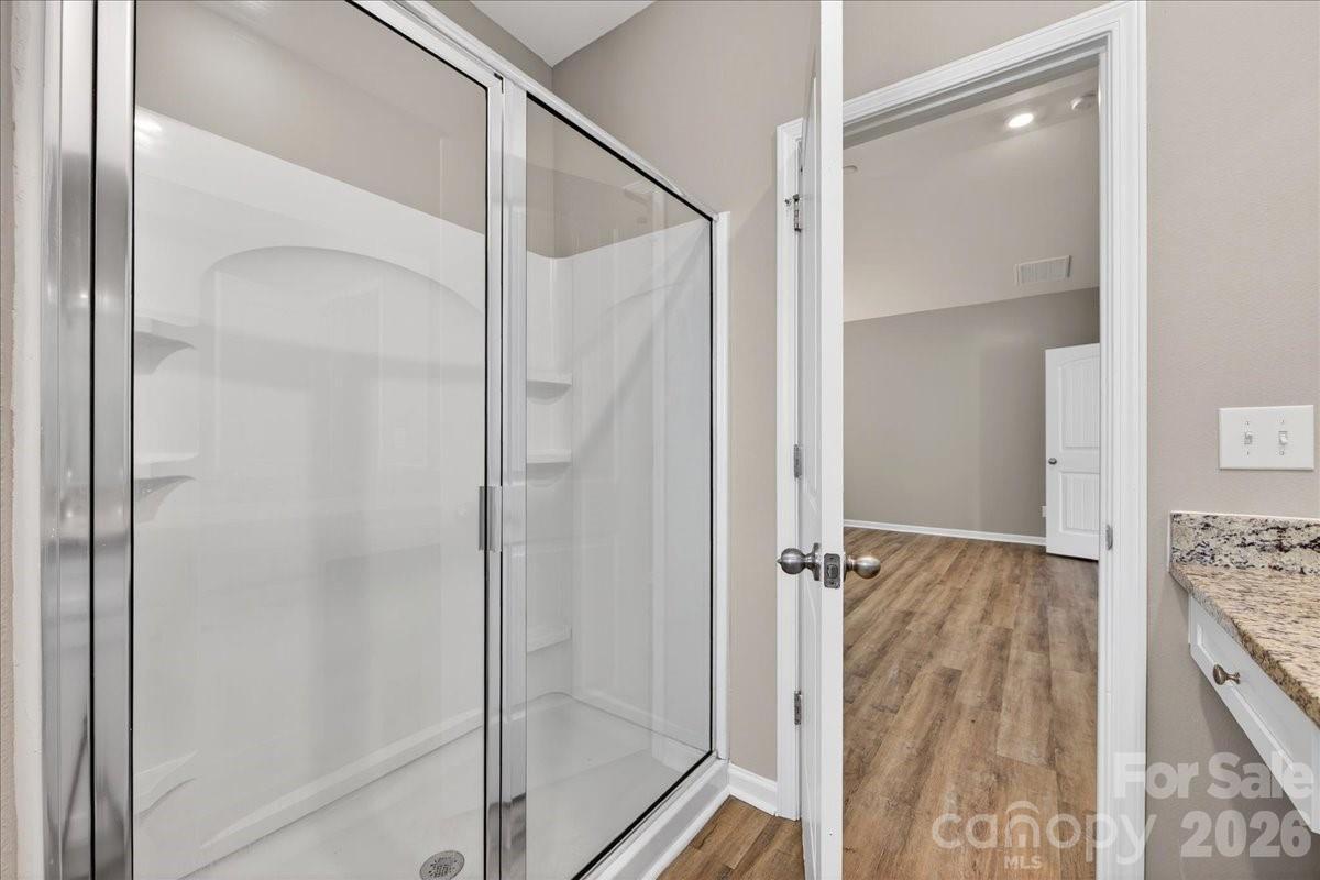 4322 One Mile Way Charlotte, NC 28215 - Photo 31 of 48 a bathroom with a glass shower door