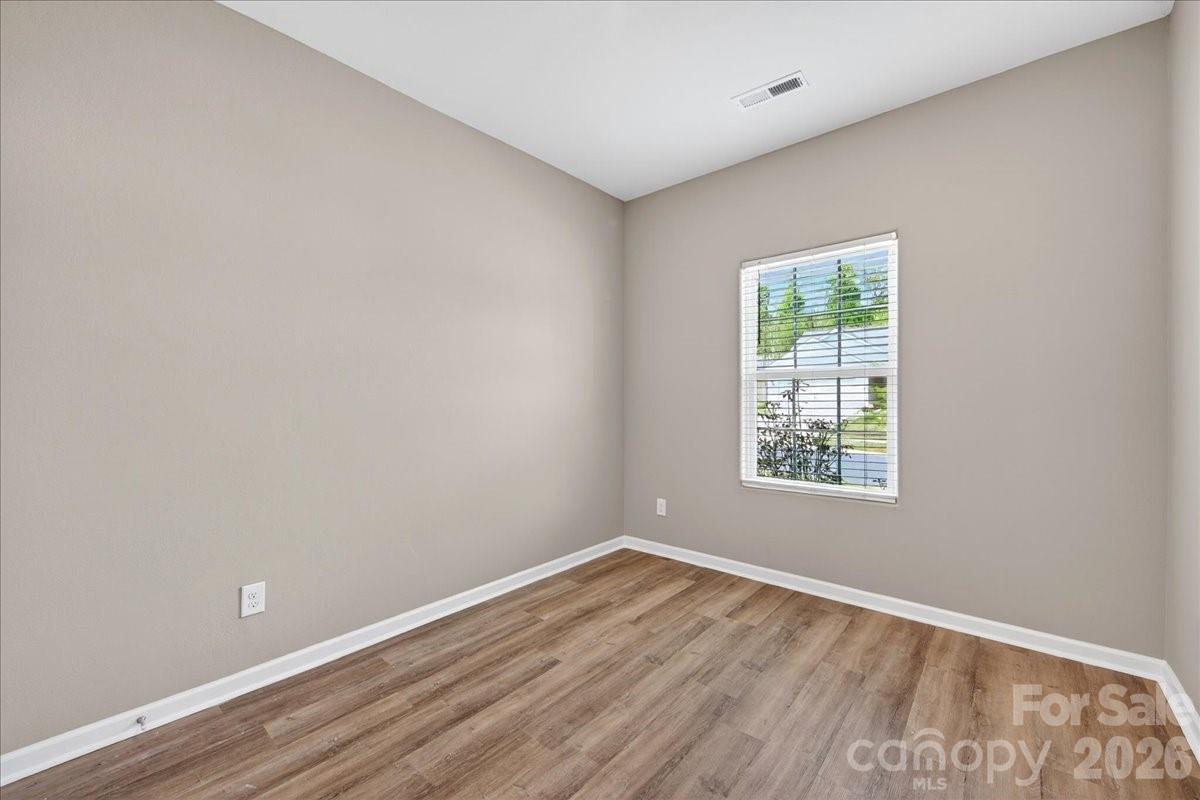4322 One Mile Way Charlotte, NC 28215 - Photo 34 of 48 an empty room with wooden floor and windows