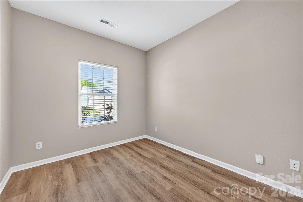 4322 One Mile Way Charlotte, NC 28215 - Photo 35 of 48 an empty room with wooden floor and windows