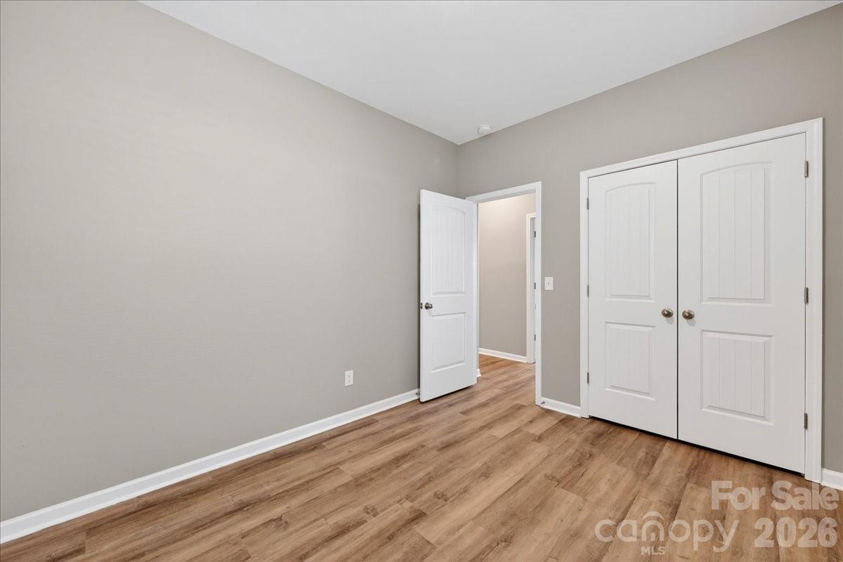 4322 One Mile Way Charlotte, NC 28215 - Photo 41 of 48 a view of an empty room with closet and wooden floor