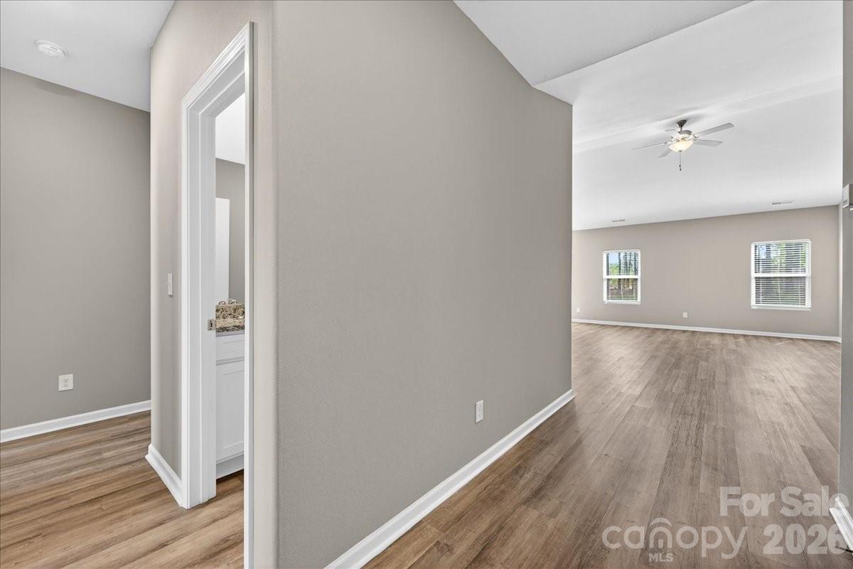 4322 One Mile Way Charlotte, NC 28215 - Photo 7 of 48 a view of empty room with wooden floor and fan