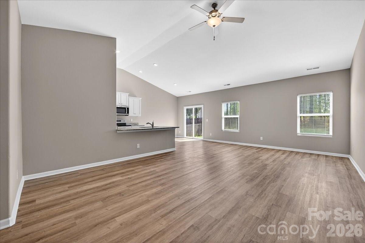 4322 One Mile Way Charlotte, NC 28215 - Photo 8 of 48 a view of an empty room with a window and wooden floor