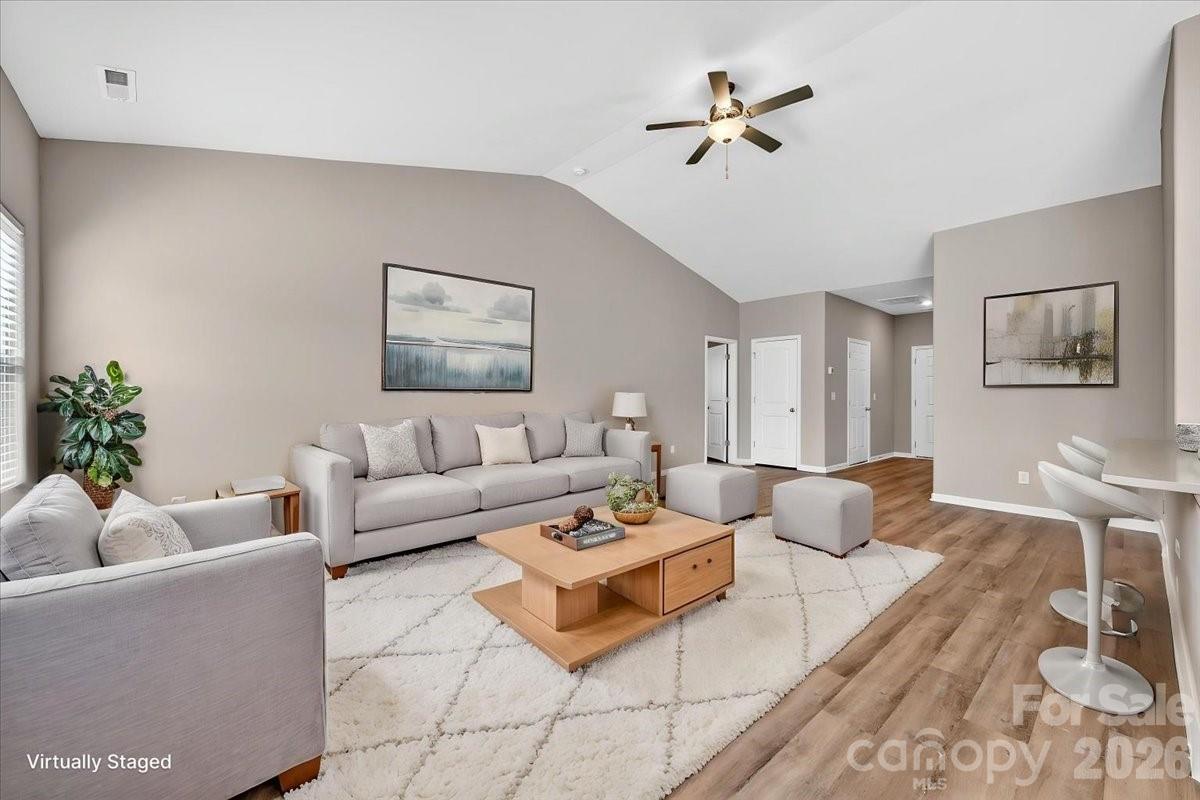 4322 One Mile Way Charlotte, NC 28215 - Photo 10 of 48 a living room with furniture a rug and a ceiling fan