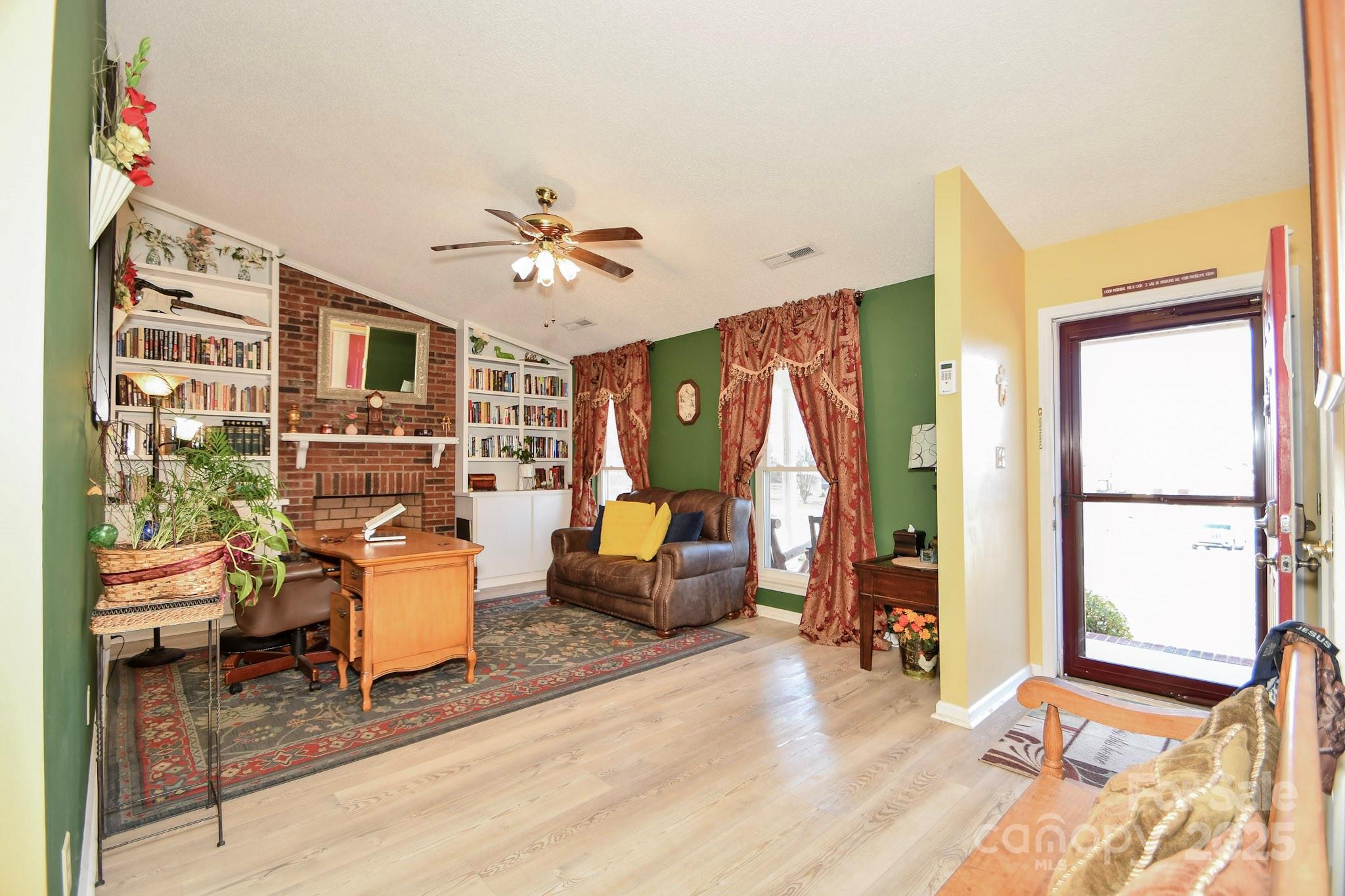 3731 Maple Knoll Drive Monroe, NC 28112 - Photo 11 of 40 a living room with furniture a flat screen tv and a large window