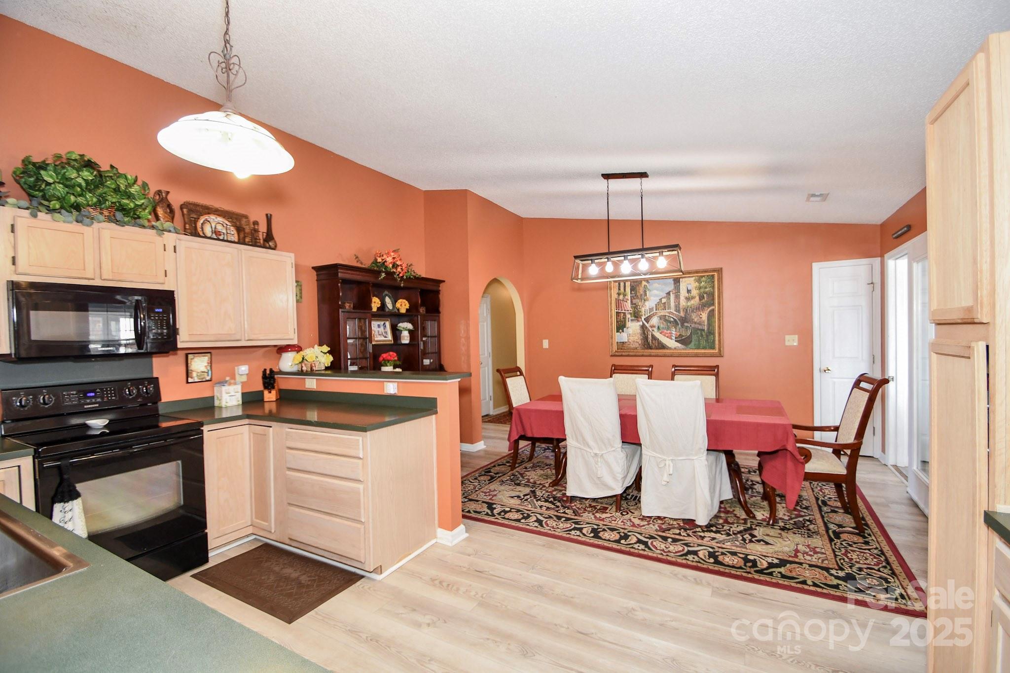 3731 Maple Knoll Drive Monroe, NC 28112 - Photo 17 of 40 a kitchen with stainless steel appliances granite countertop a stove a sink and a microwave
