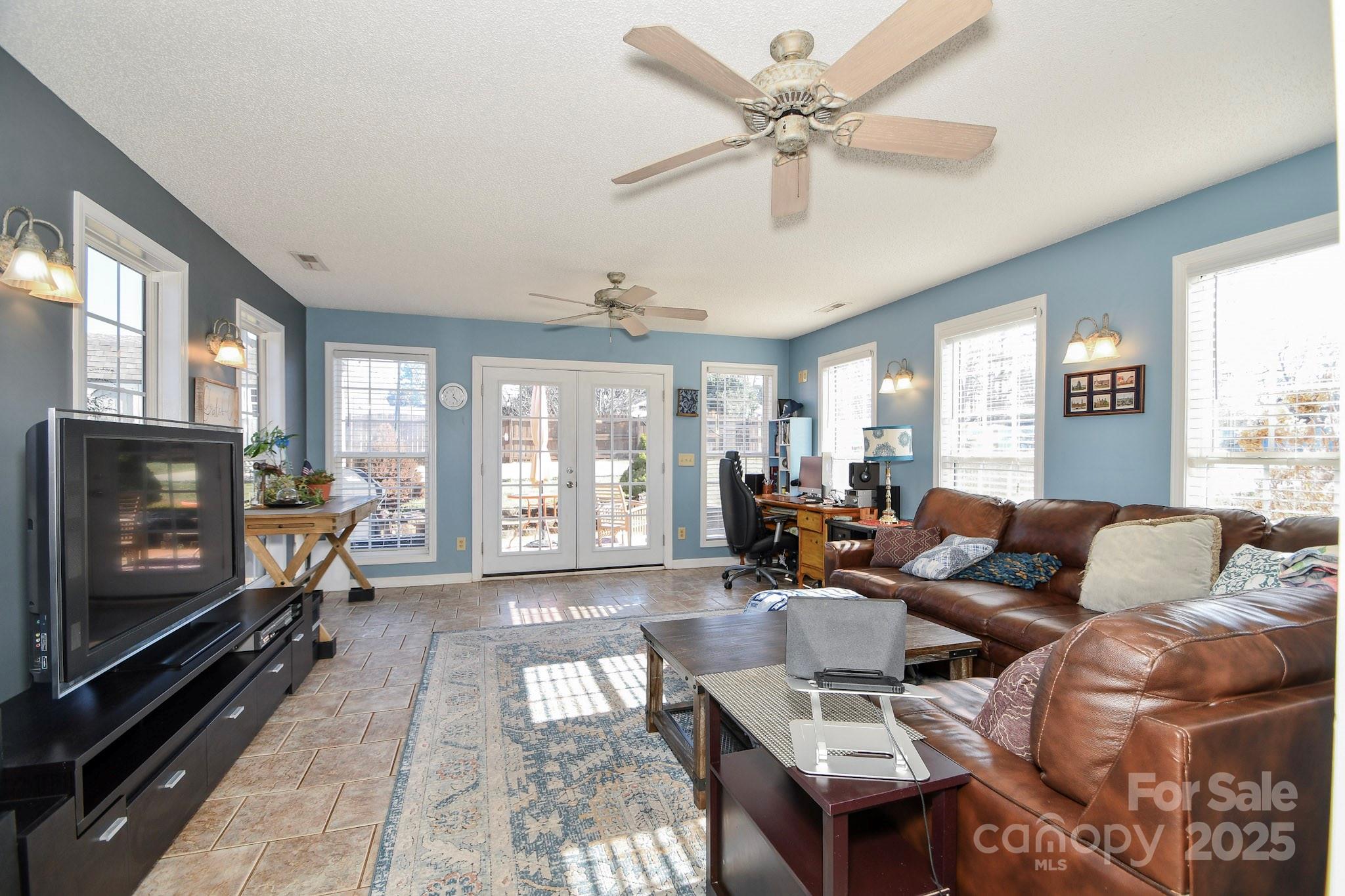 3731 Maple Knoll Drive Monroe, NC 28112 - Photo 18 of 40 a living room with furniture a flat screen tv and a fireplace