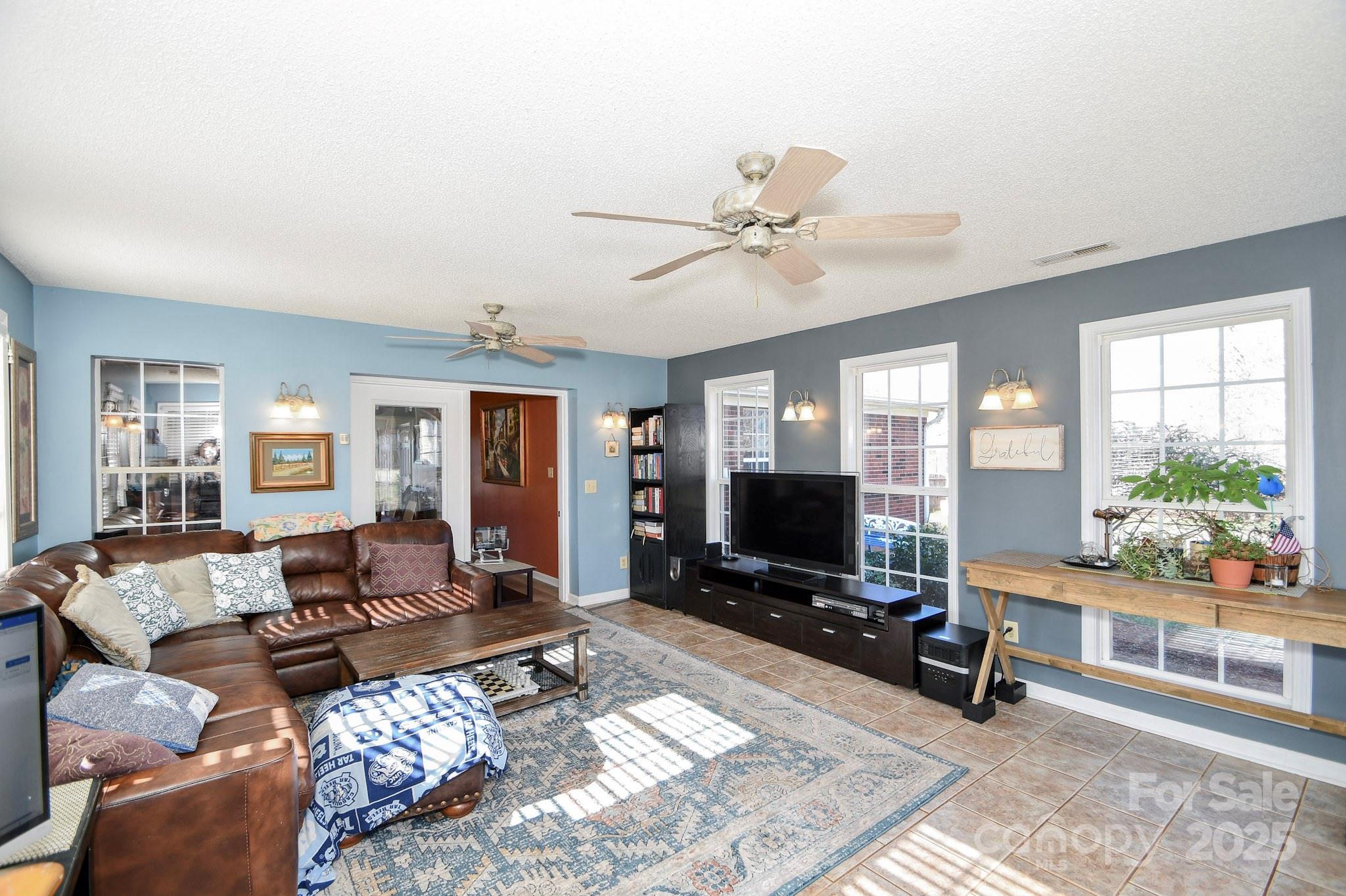 3731 Maple Knoll Drive Monroe, NC 28112 - Photo 19 of 40 a living room with furniture a flat screen tv and a large window