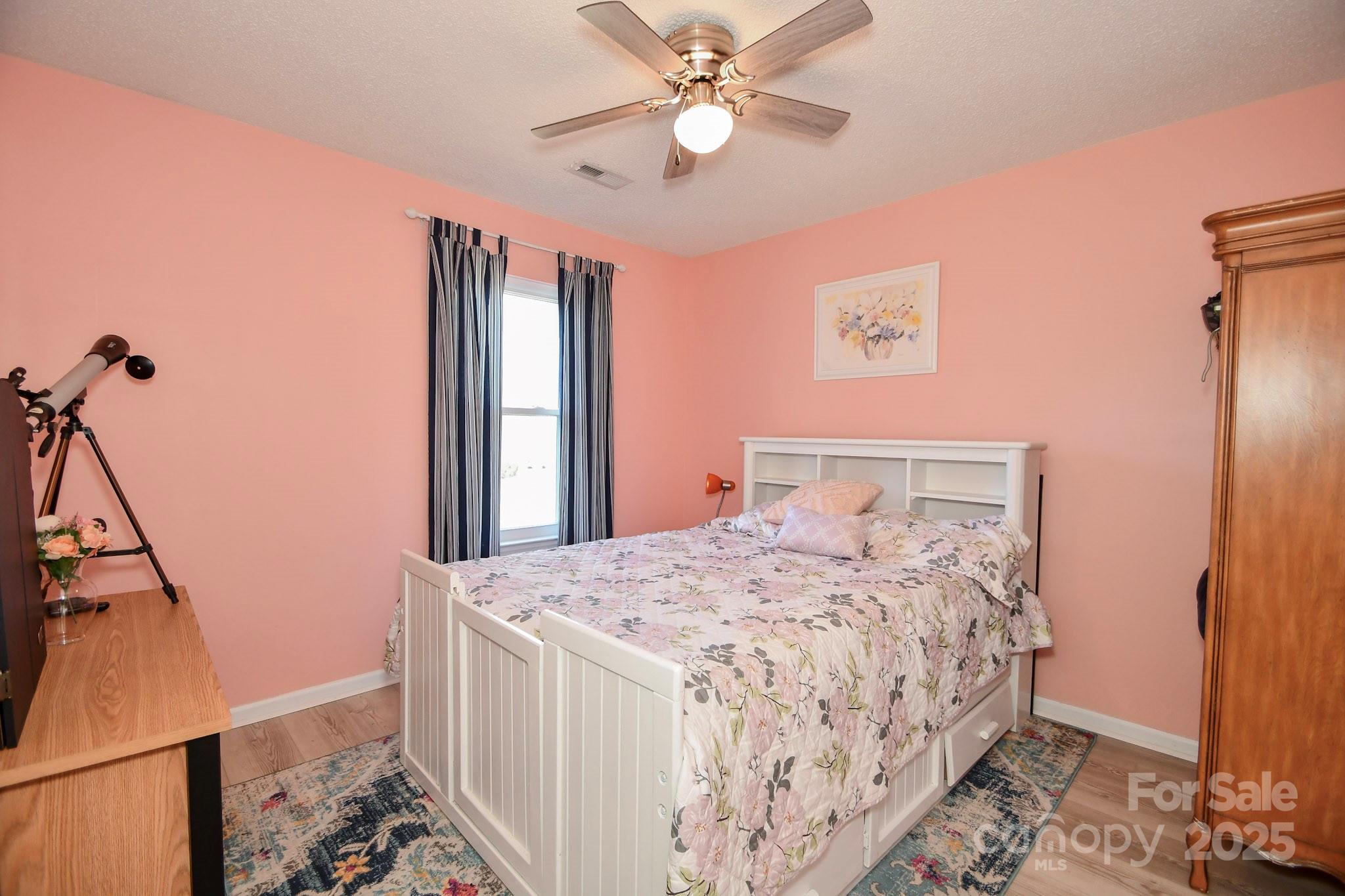 3731 Maple Knoll Drive Monroe, NC 28112 - Photo 20 of 40 a bedroom with a bed and a chandelier
