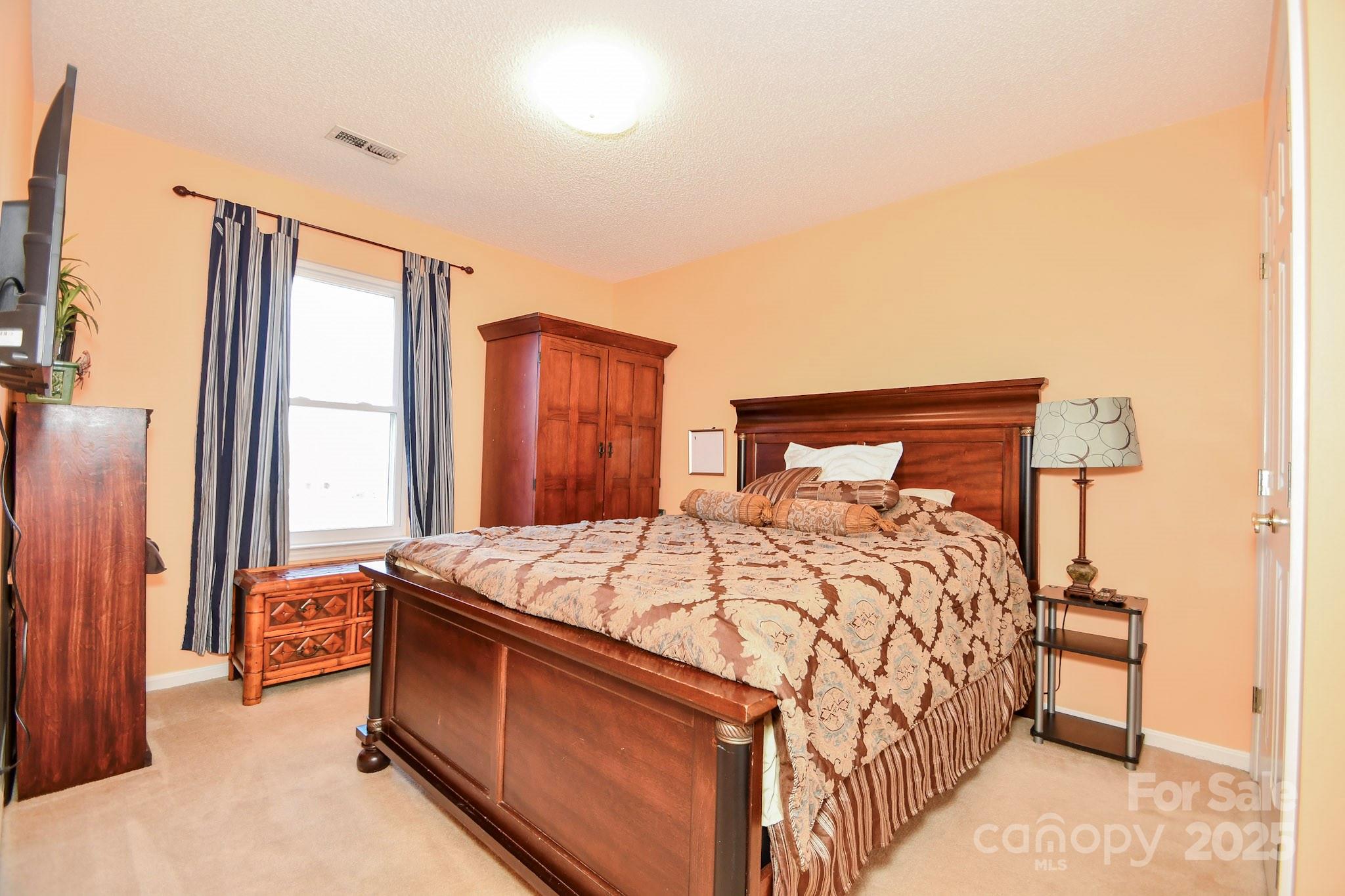 3731 Maple Knoll Drive Monroe, NC 28112 - Photo 21 of 40 a bed sitting in a bedroom next to a window
