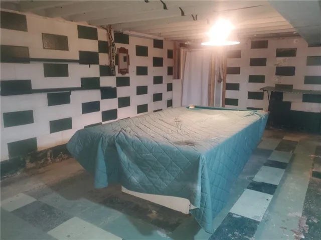 a bedroom with a large window and a walk in closet