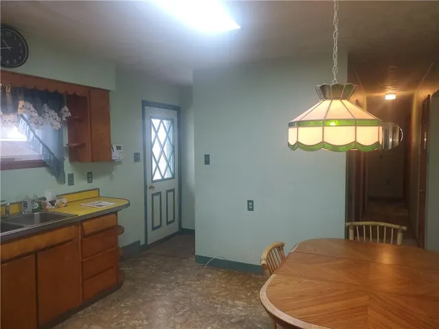 a bathroom with a sink a light fixture and a mirror