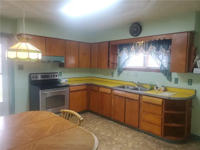 a kitchen with a sink window and cabinets