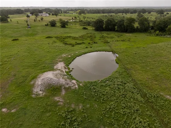 a view of a field with an ocean