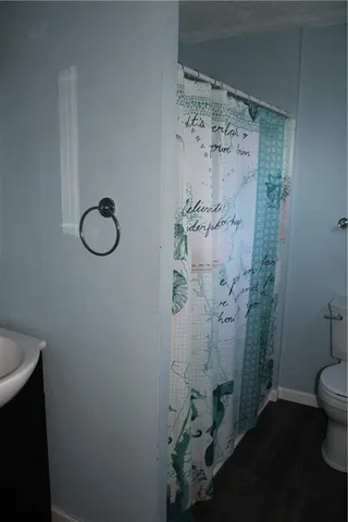 an empty room with windows mirror and brick walls