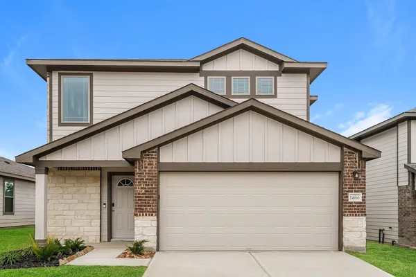 a view of a house with a yard and garage