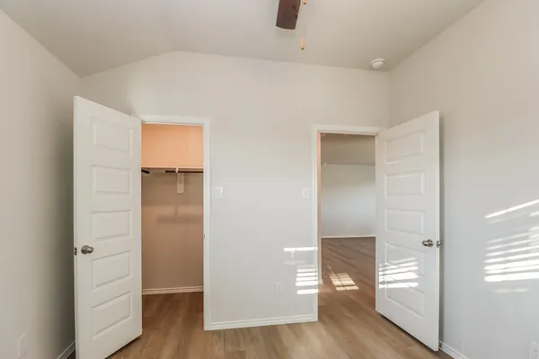 a view of an empty room and wooden floor