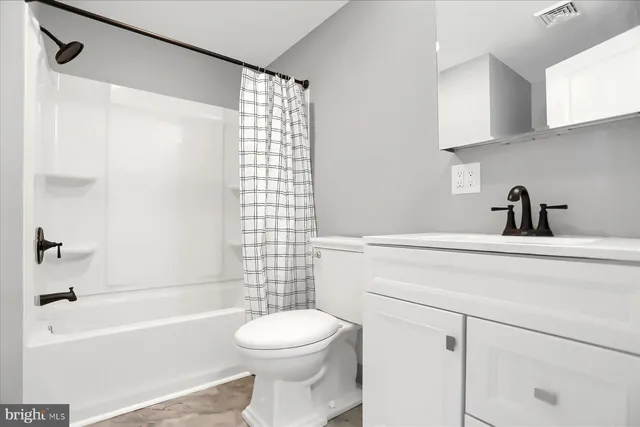 a view of a street with wooden fence