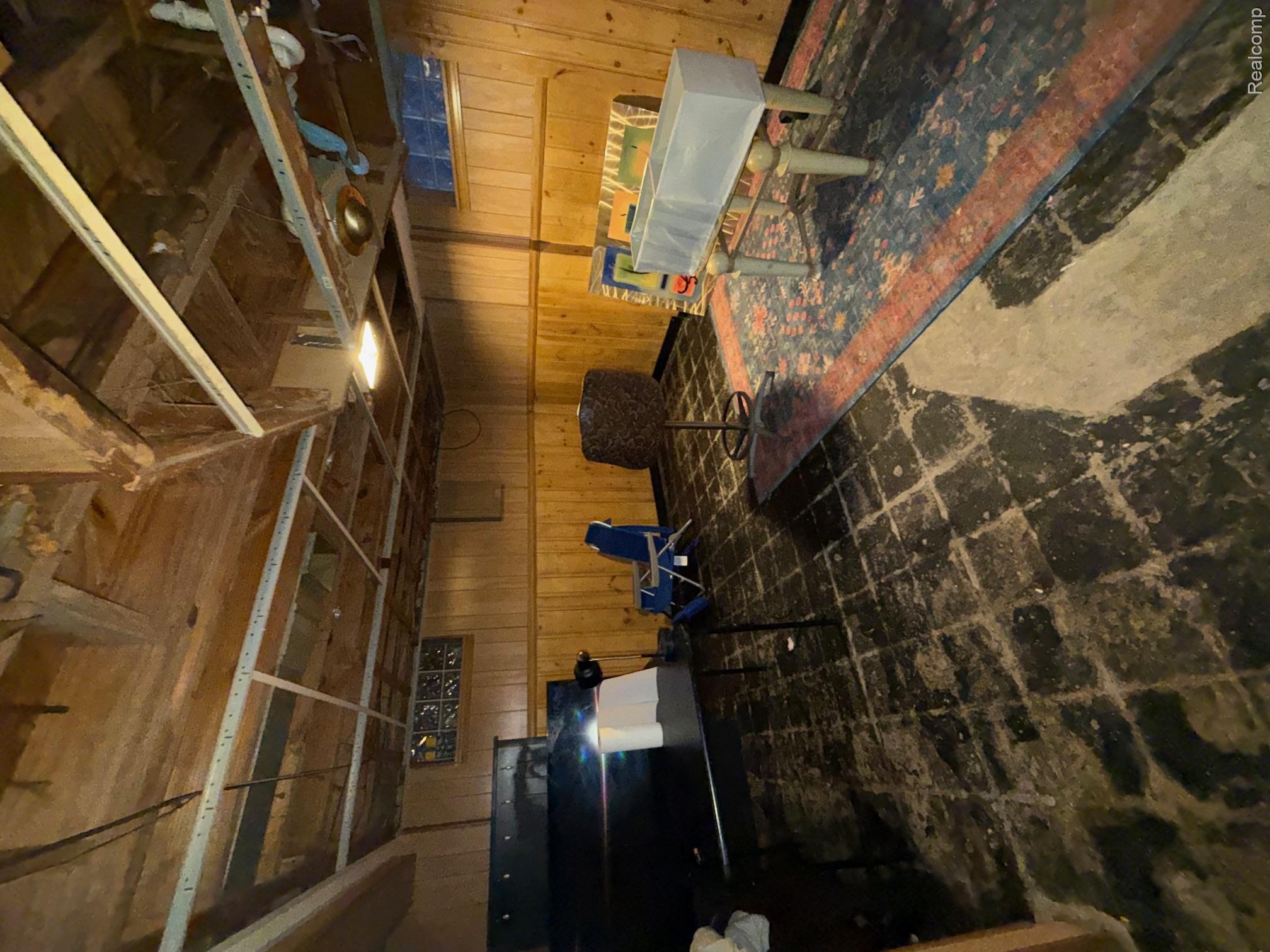 19464 Trinity Street Detroit, MI 48219 - Photo 5 of 7 Recreation room with wood walls and concrete flooring