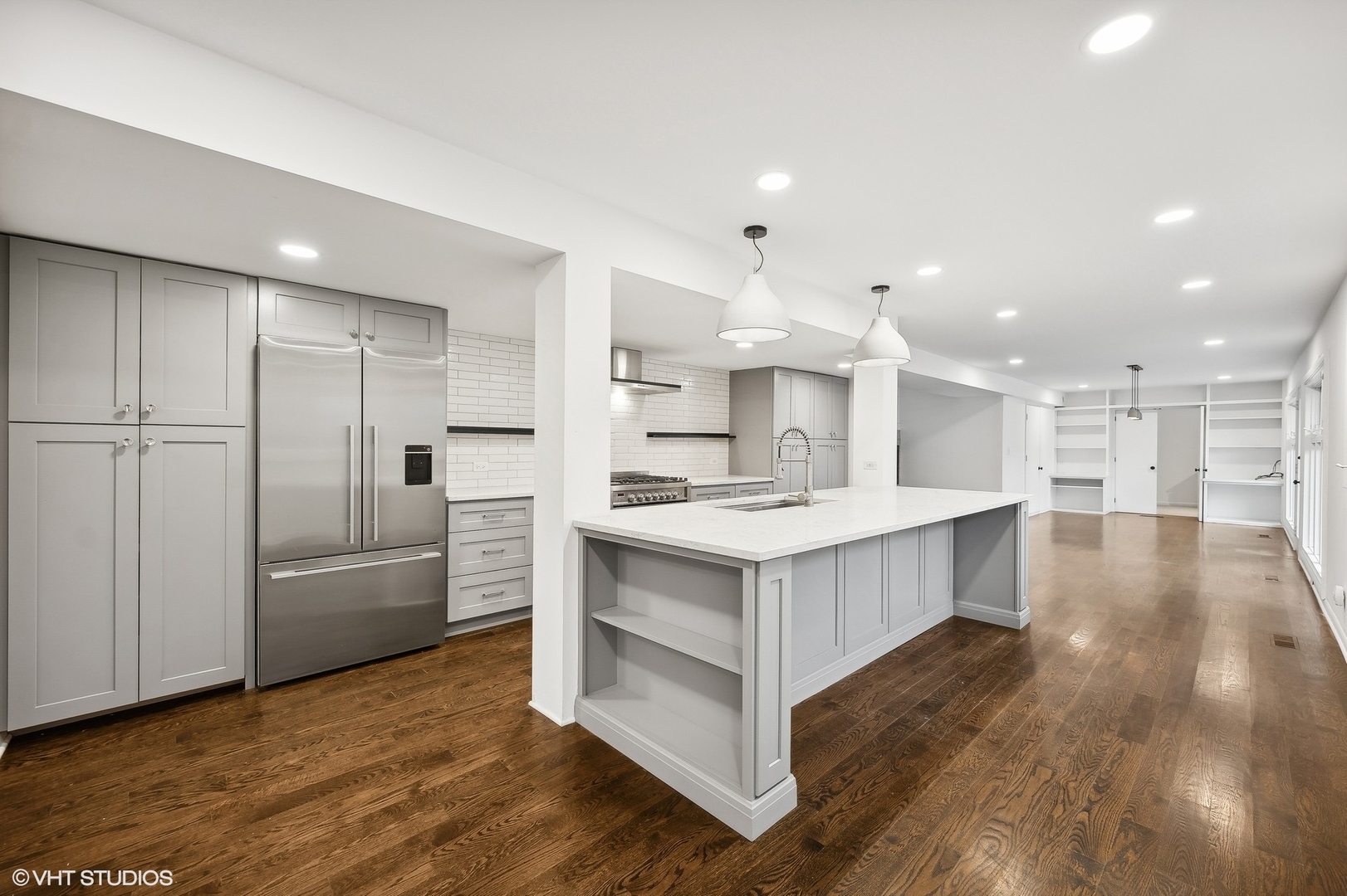 558 Sunset Lane Glencoe, IL 60022 - Photo 7 of 22 a large kitchen with a large counter top a sink stainless steel appliances and cabinets